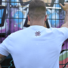 white t-shirt vandalist europe, graffiti in background